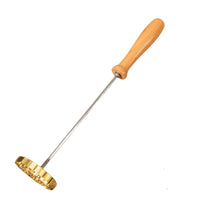 Gold-colored tool with a wooden handle on a white background